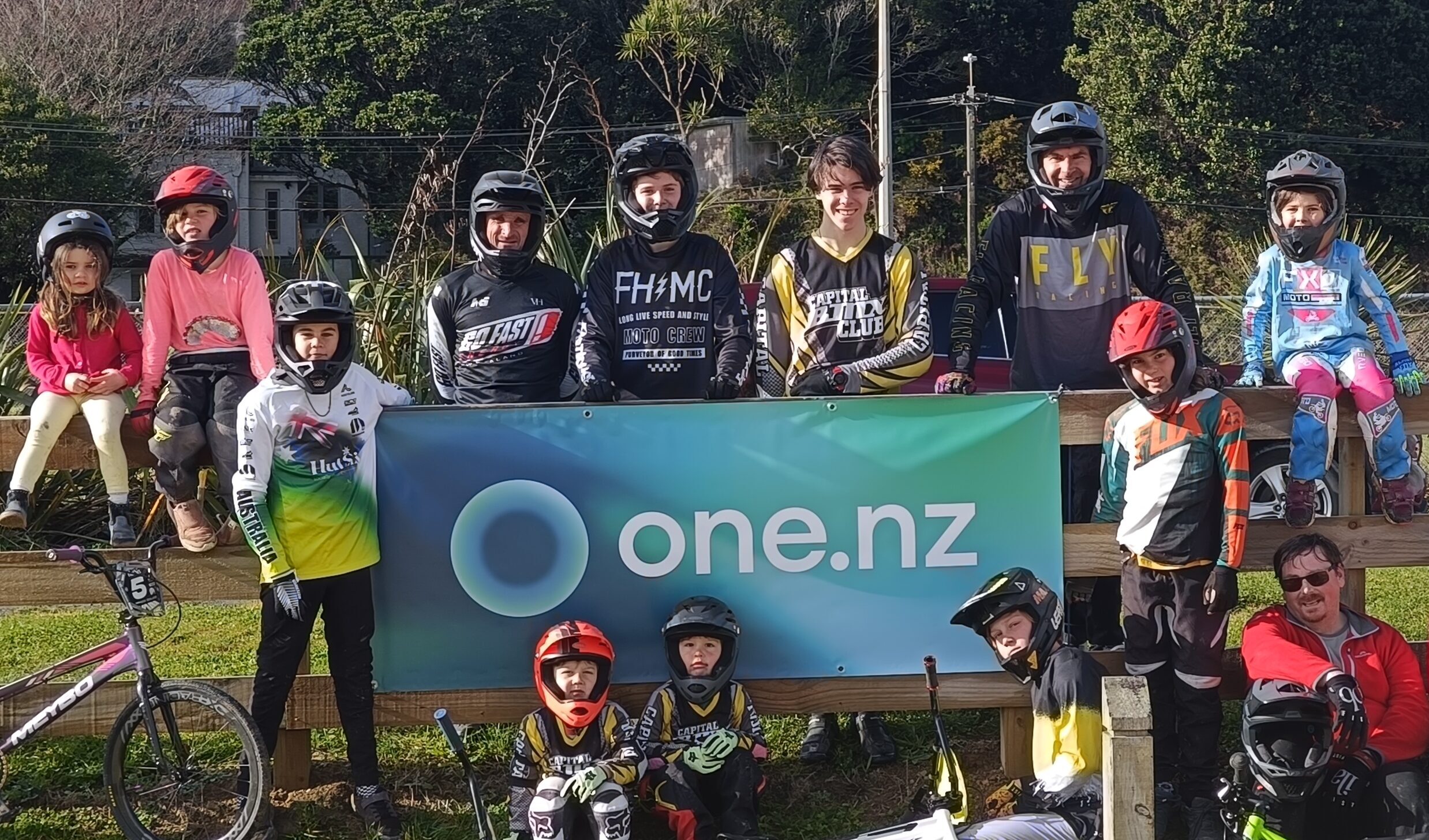 Capital BMX riders around the One NZ fence banner